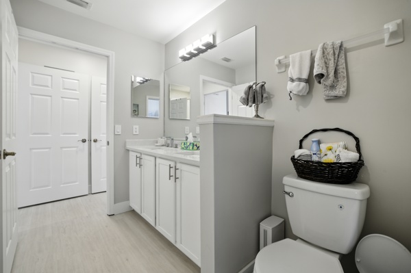 Full bathroom by the guest king bedroom with dual-sink vanity and shower tub combination at Pinnacle, Unit 2503 Naples FL
