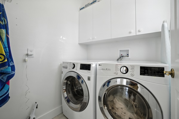 In-unit laundry with LG Smart washer and dryer and storage at Pinnacle, Unit 2503 Naples