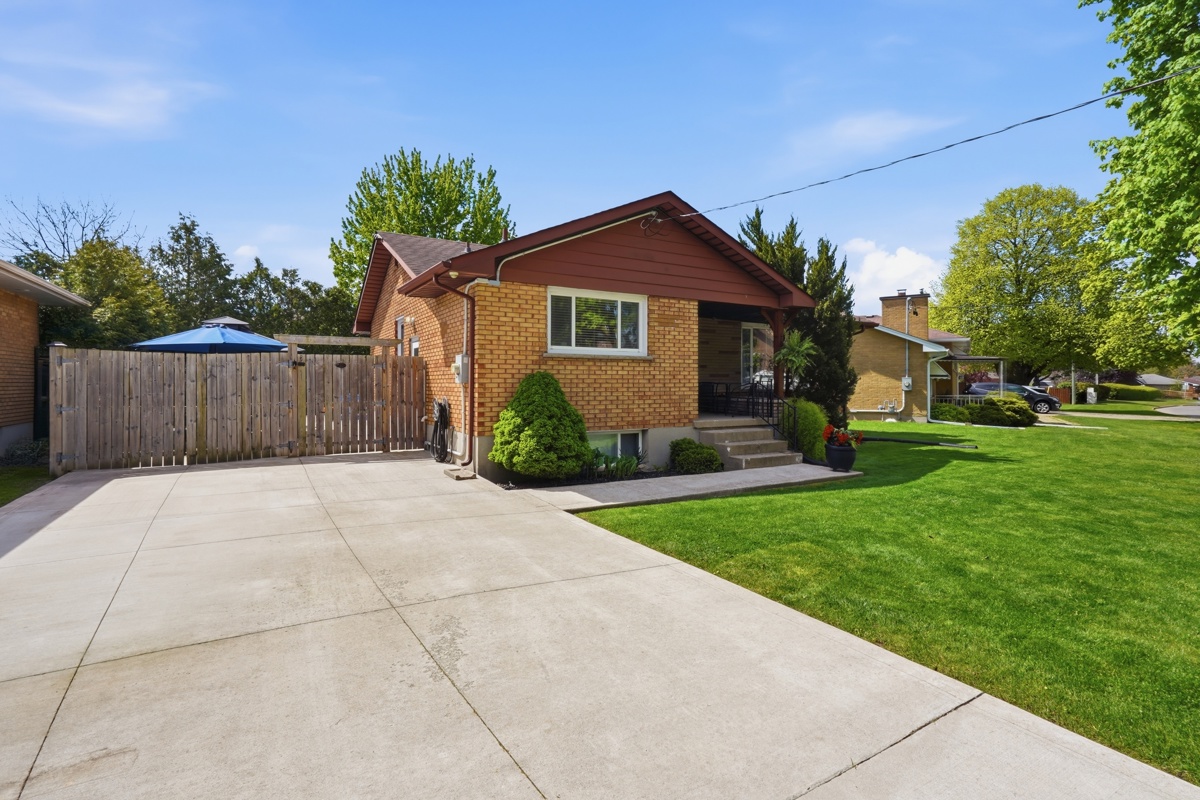 Side view — concrete driveway with RV parking, East London